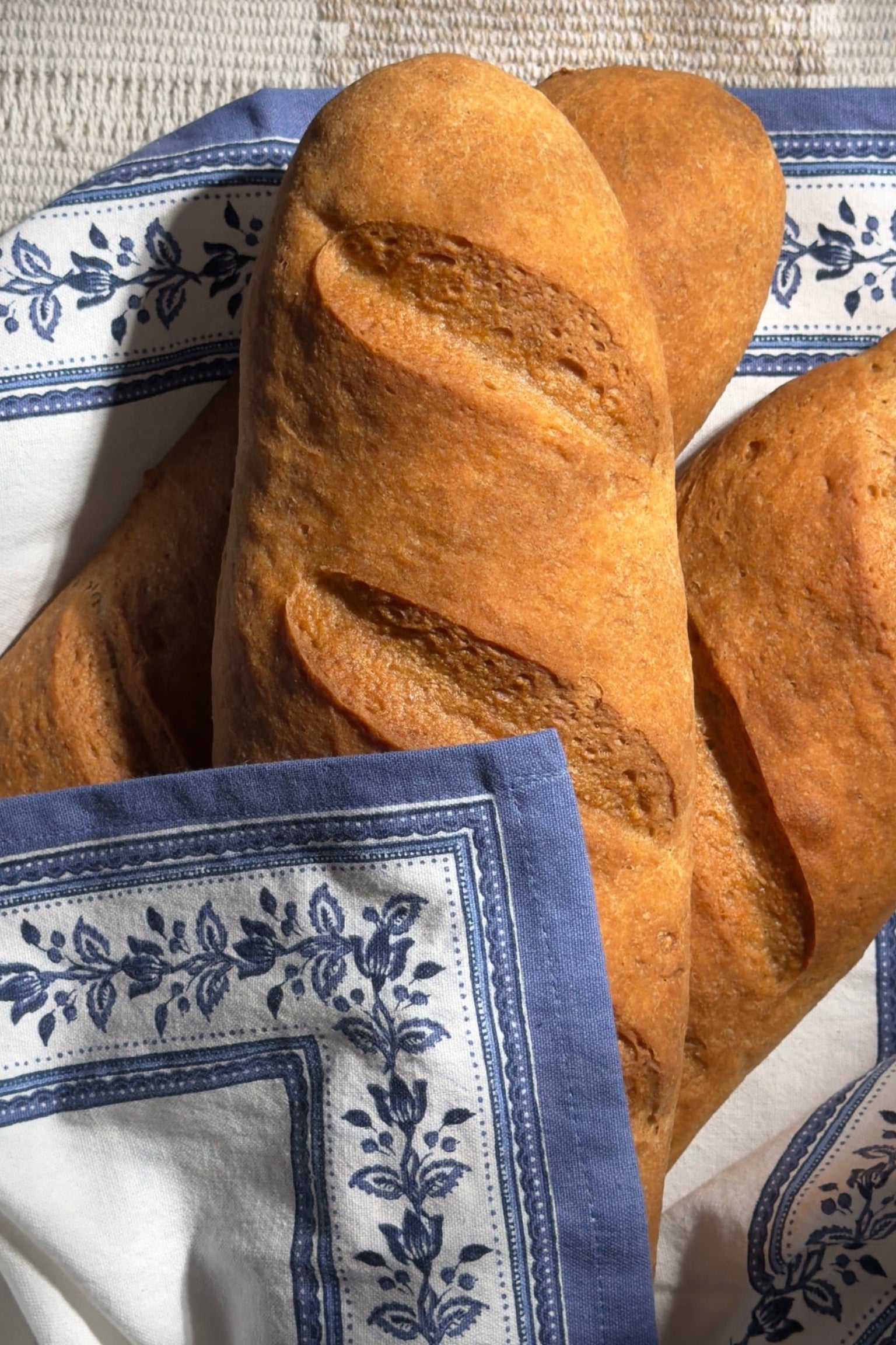 Loaf of bread on a blue and white patterned cloth